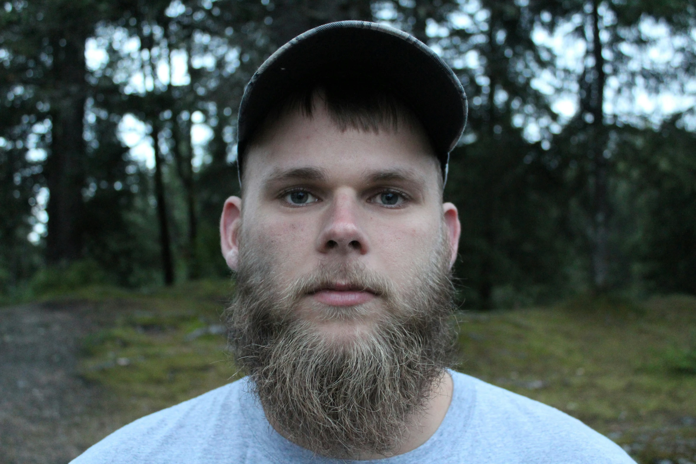 a man with a baseball cap looking away from the camera