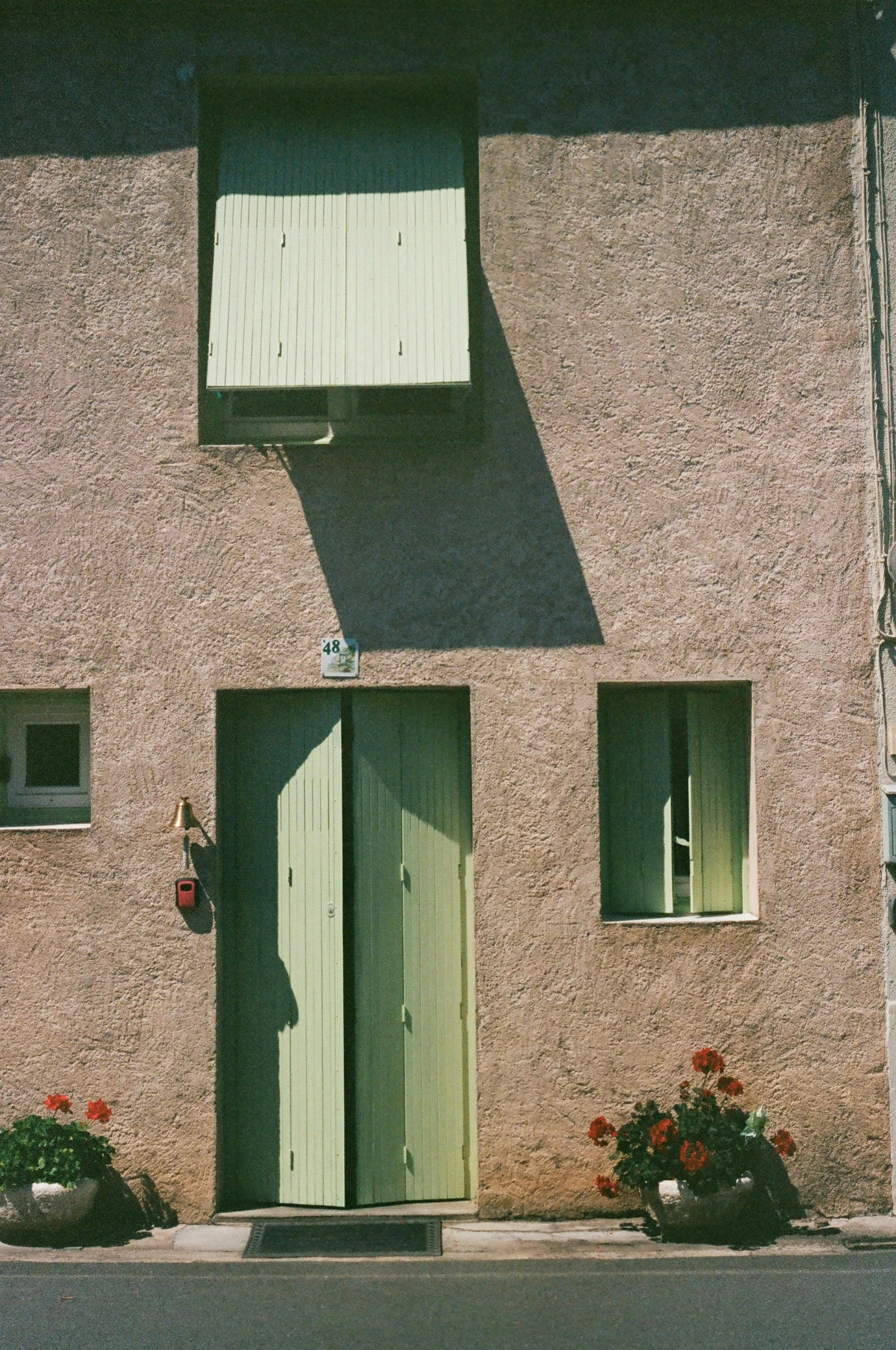 two small doors that are by some flowers