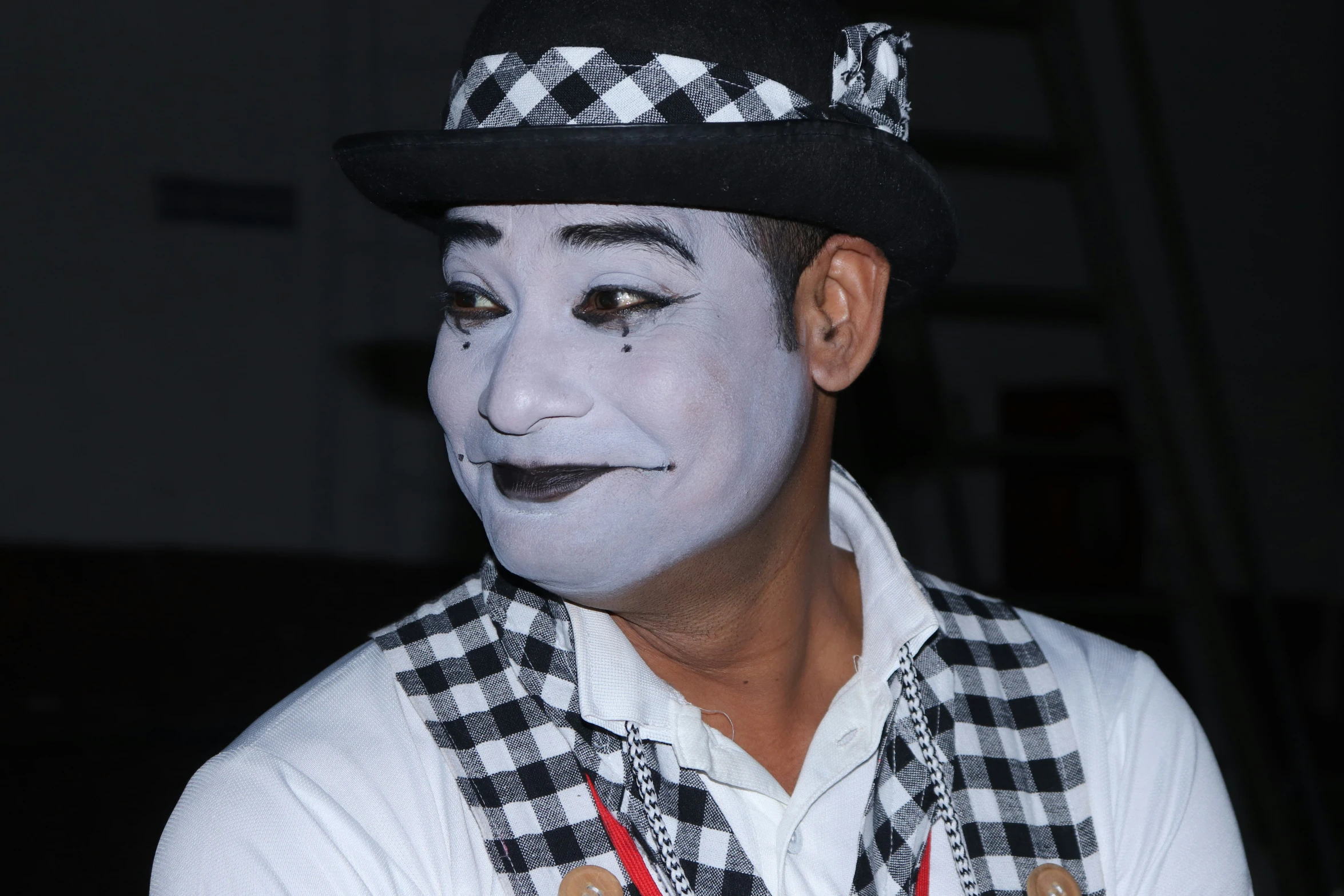 a man is dressed in a white clown makeup