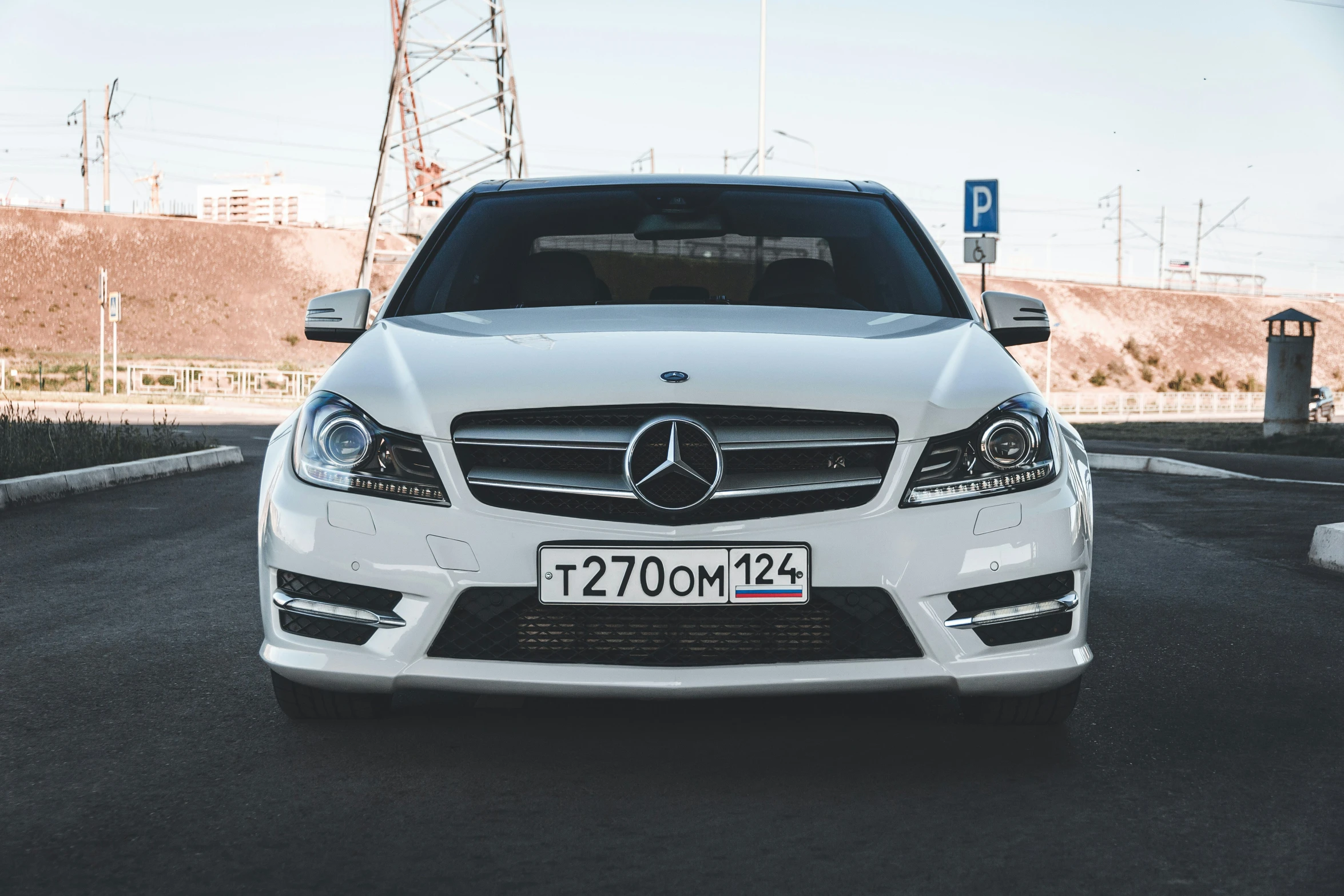 a white car that is parked in the street