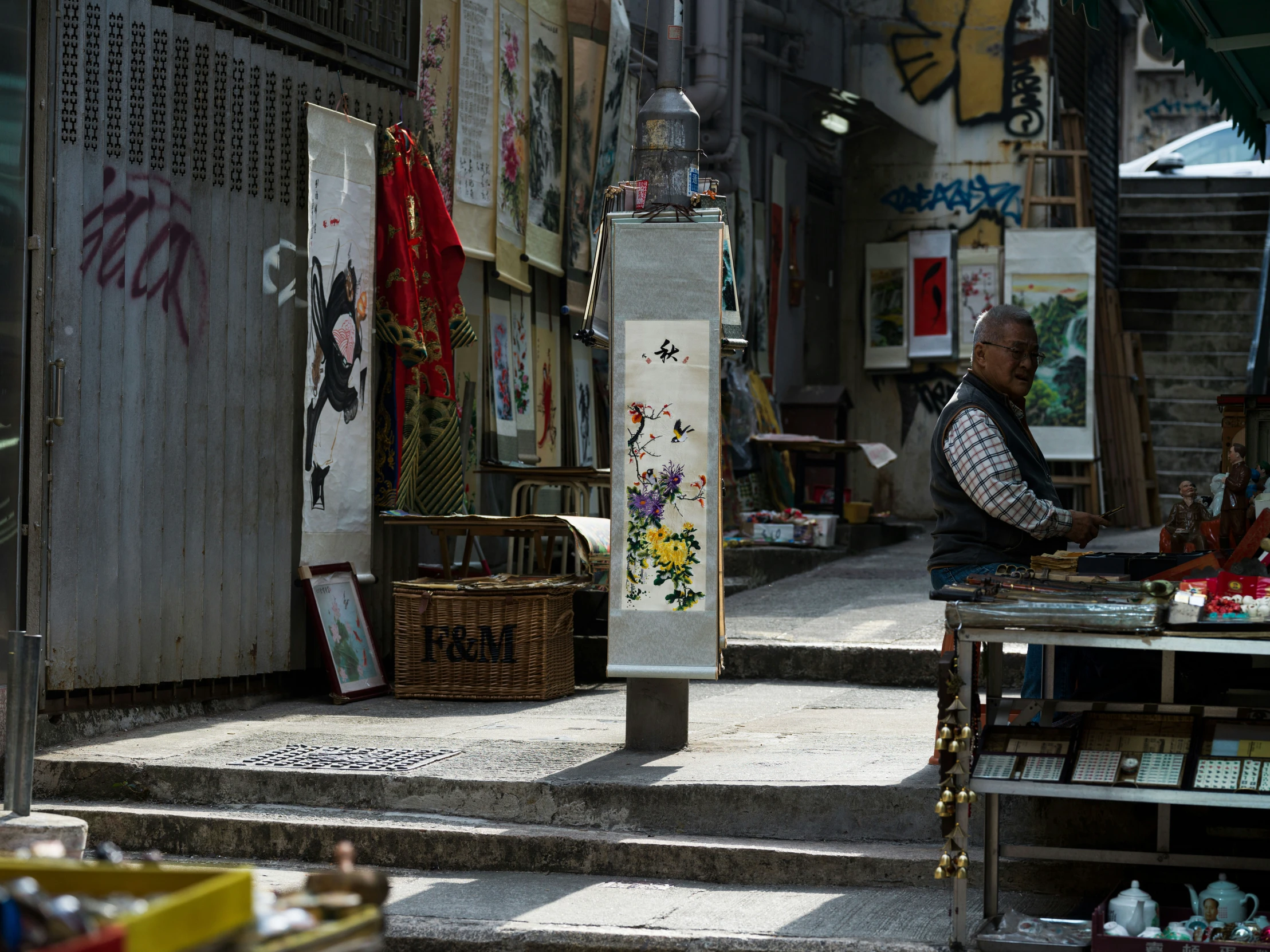 man sitting in an open market looking into the distance