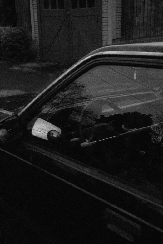 a street view at night shows an abandoned car