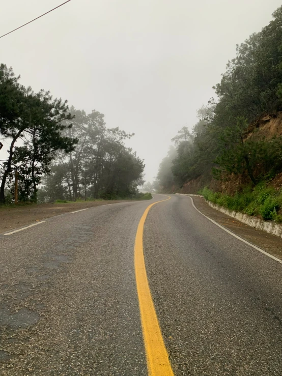 a rural highway on a cloudy day with trees