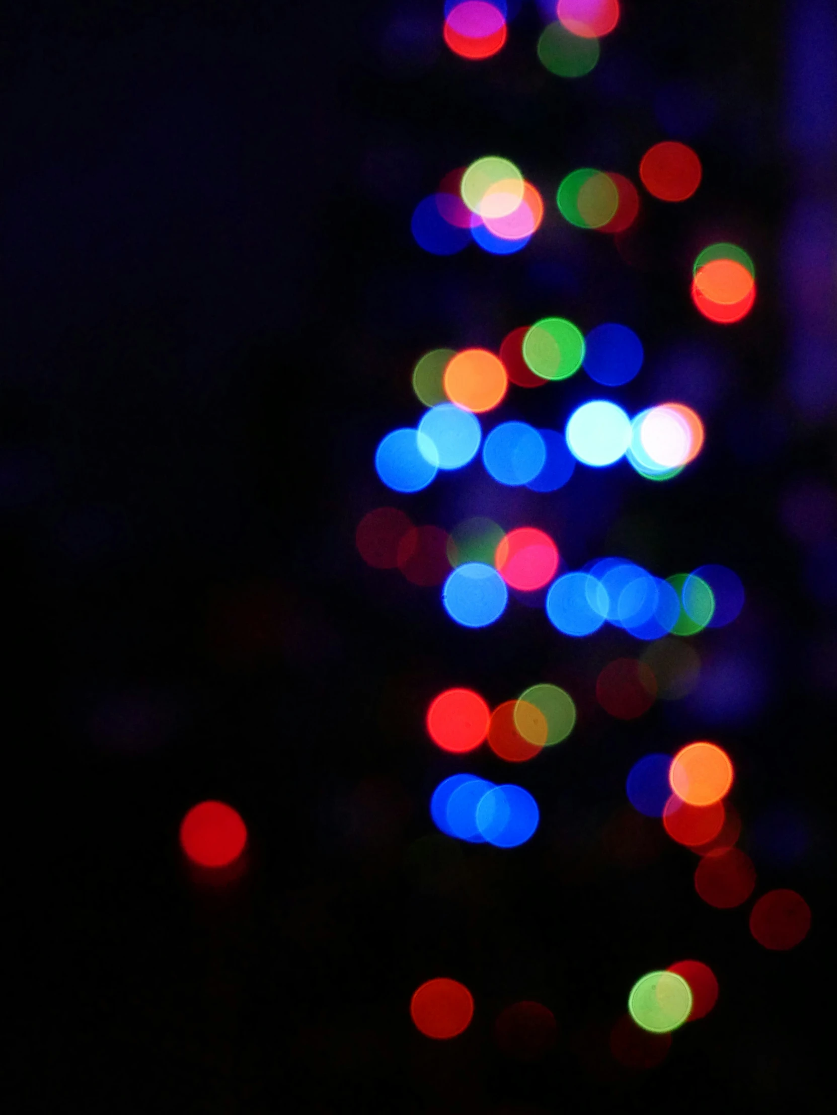 brightly lit christmas tree sitting on the floor