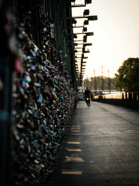 a person riding a bike past a bunch of locks