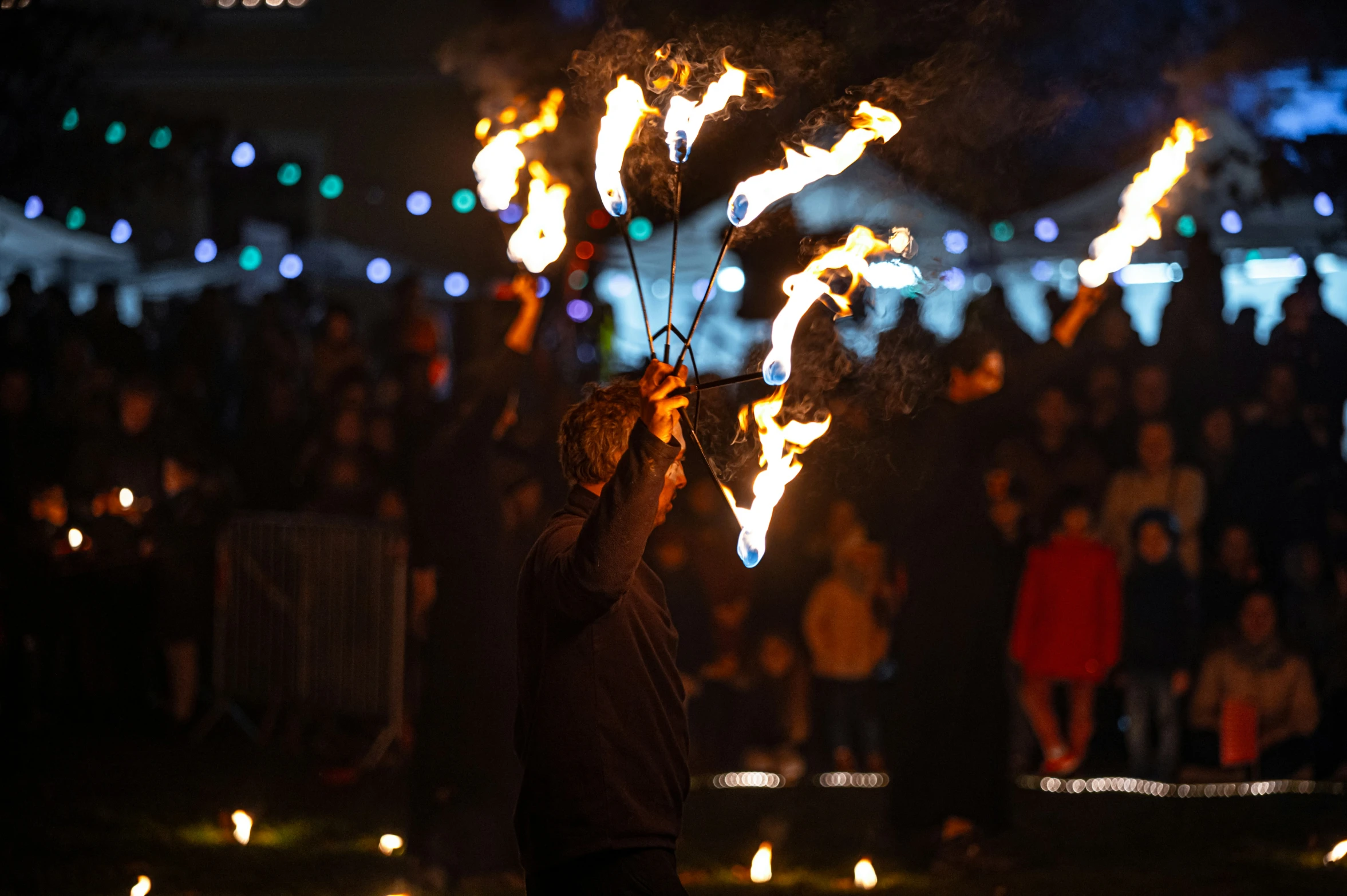 a person holds onto sparklers at night