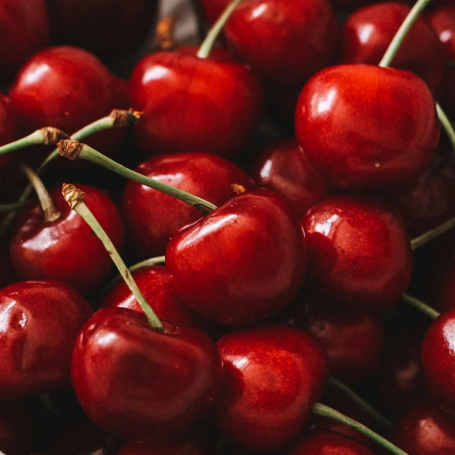 a bunch of red cherries are sitting on the table