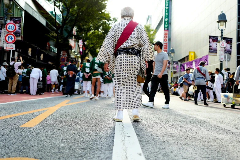 a skateboarder is riding down the street in a dress