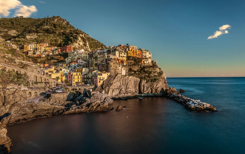 a colorful village is sitting on a cliff