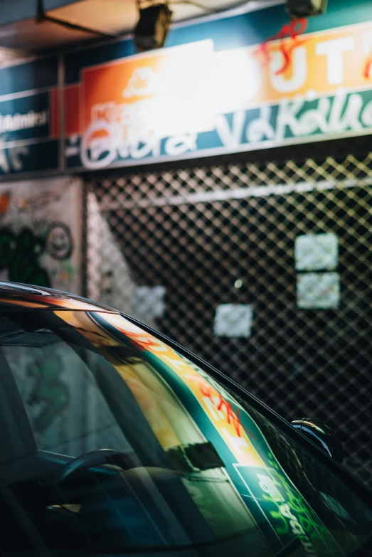 an older style taxi cab with colorful stickers and a window in the foreground