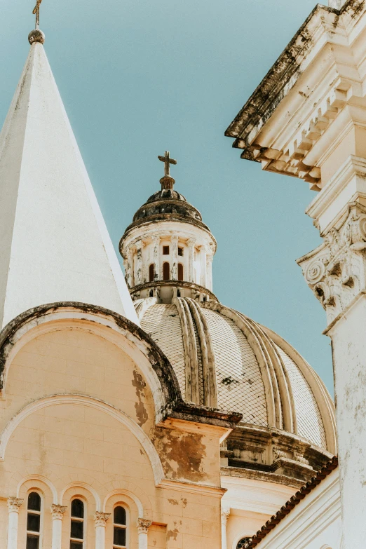 a church with a tall steeple and two crosses