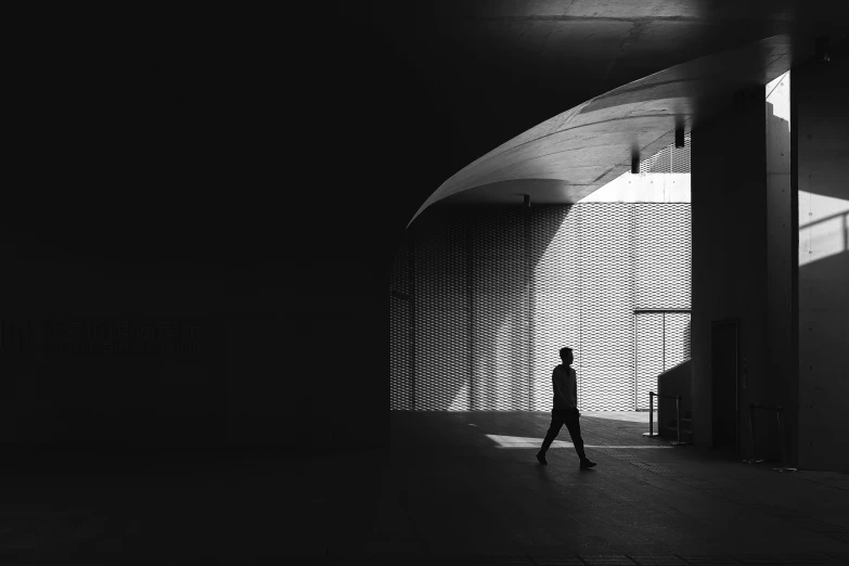 a person walks in the light through the door of a building
