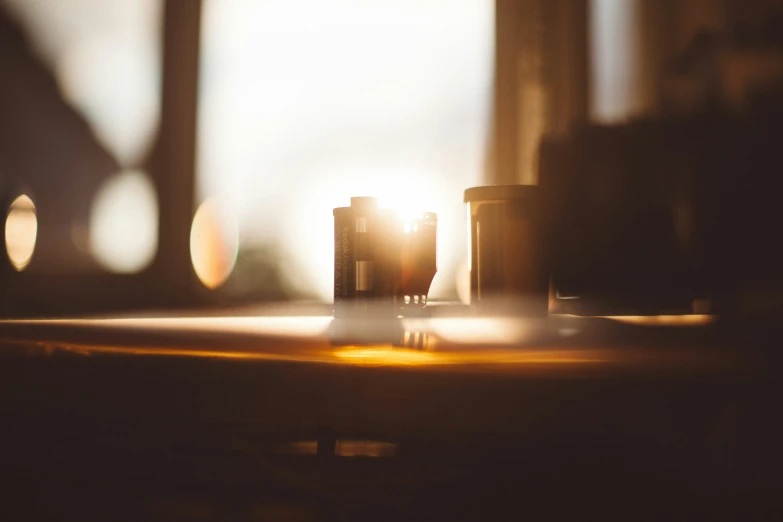 a light shines through two cups on a table