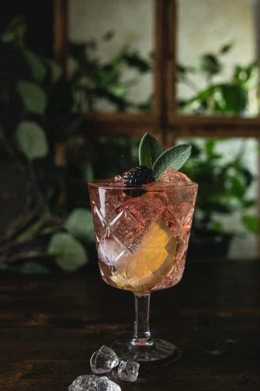 a black and lemon cocktail with ice on the table