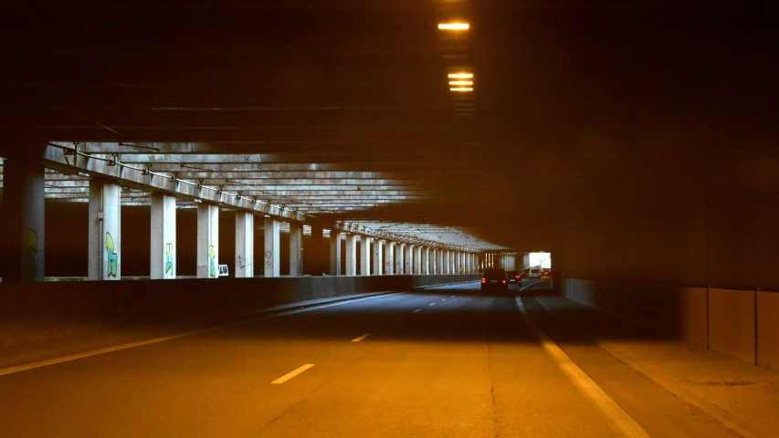 the shadows of pillars on the side of the road