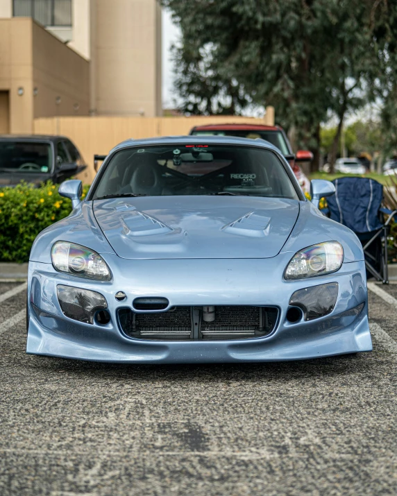 a blue sports car parked in a parking lot