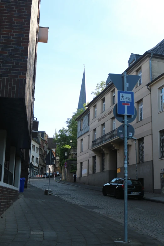 a blue sign is on the street in an old city