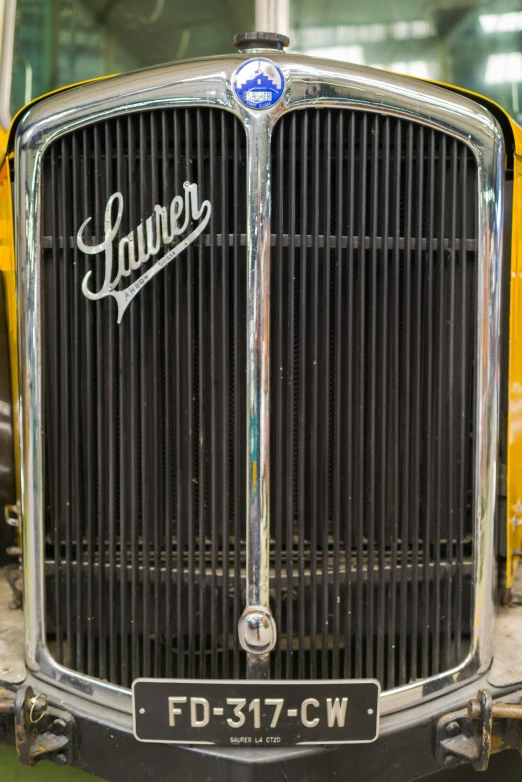 an older model truck, painted yellow and white with the name laverer