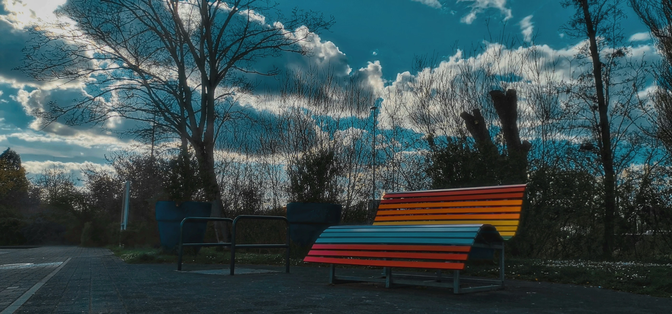 an empty park bench with different colors on it