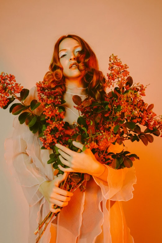 a woman with flowers on her face holding a nch