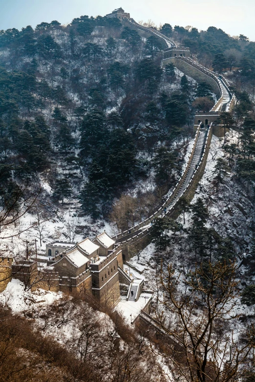 a train traveling up a railroad track near a large mountain