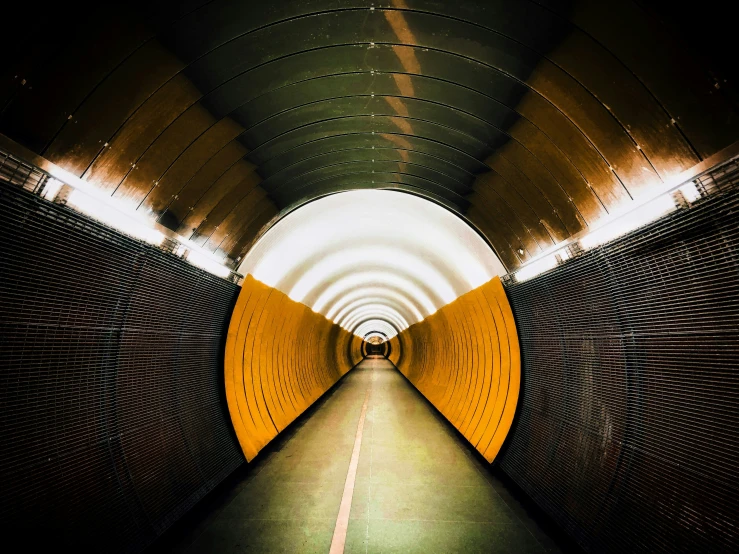 a long tunnel with a bright yellow sign next to it
