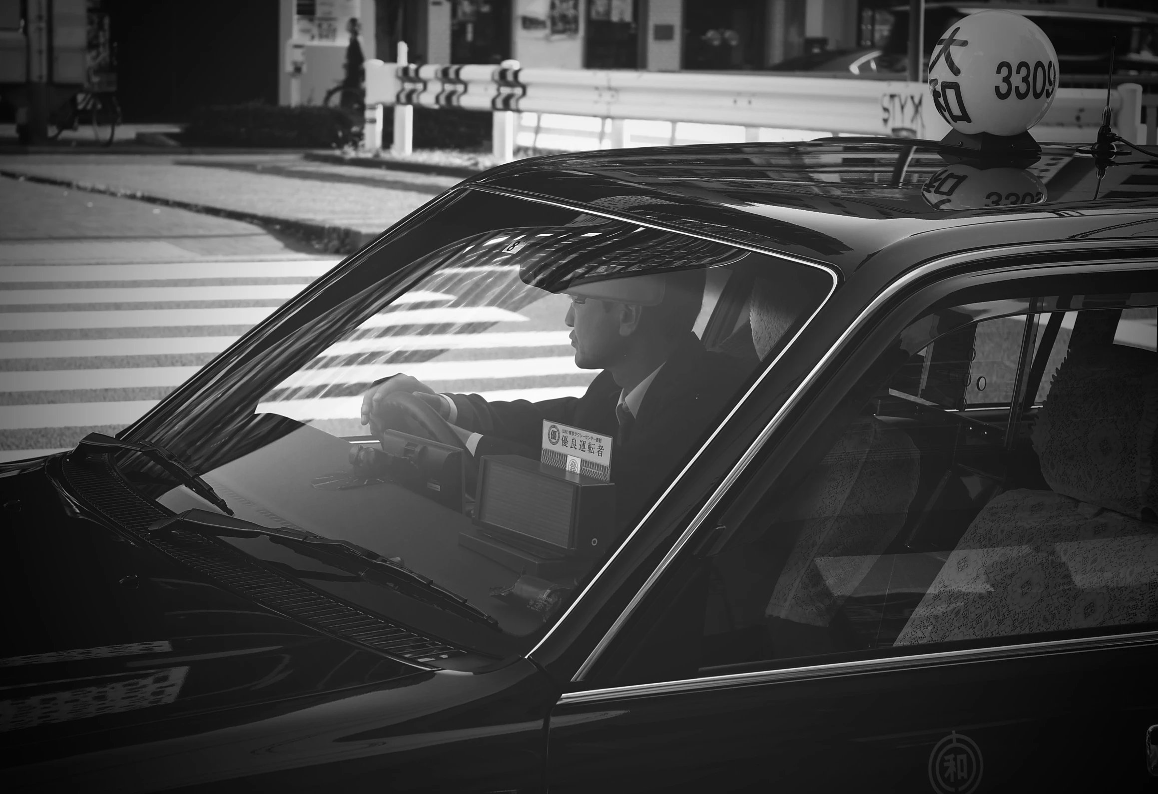 the man is sitting in his taxi on the road