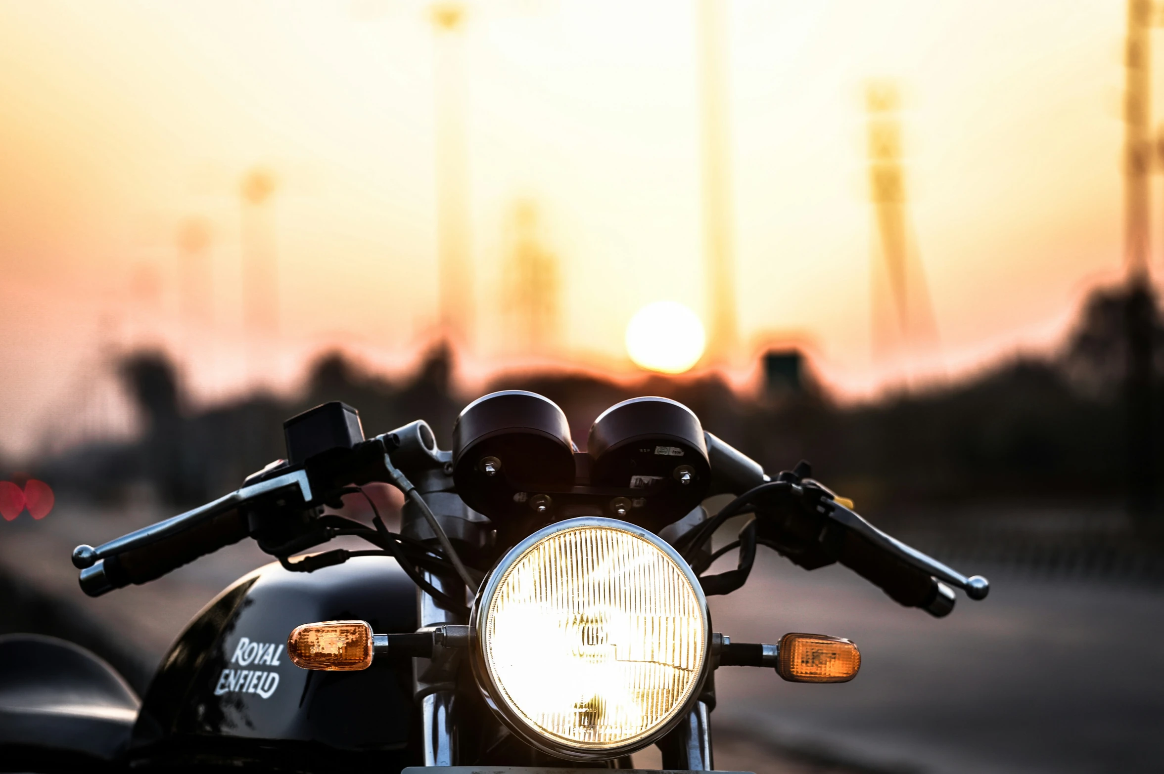 the front end of a black motorcycle parked in front of a street light