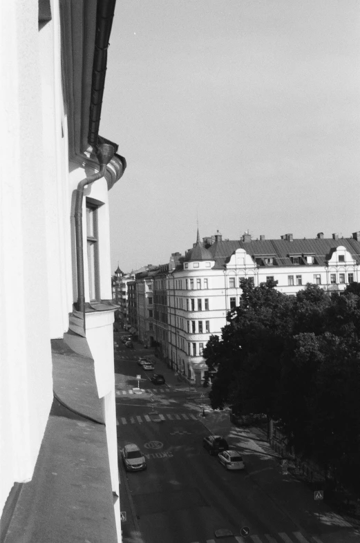 an outdoor balcony with cars parked on the road