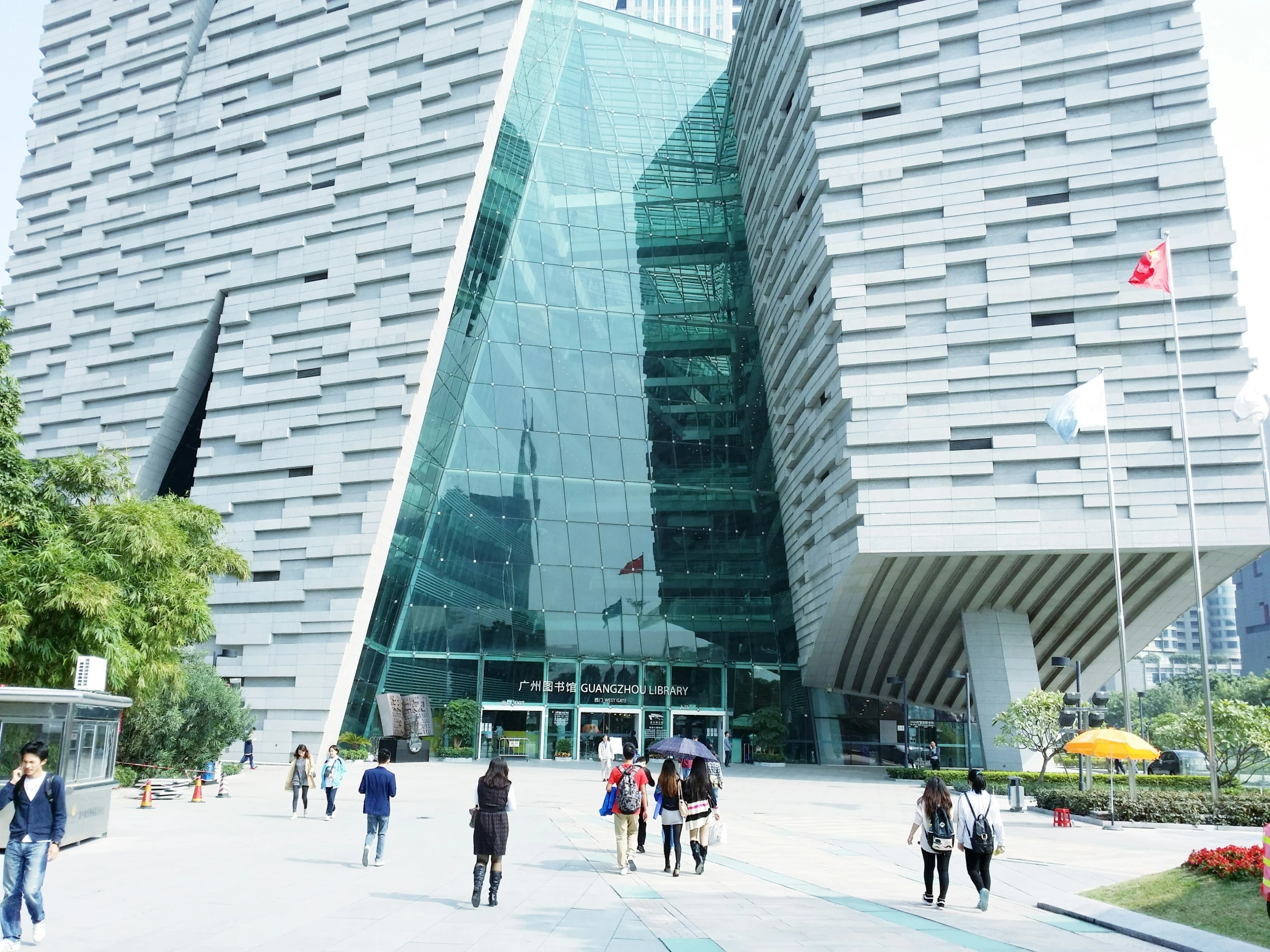 people walk around in front of large office building