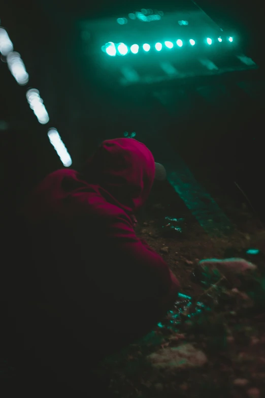 man sitting on the ground watching soing on stage