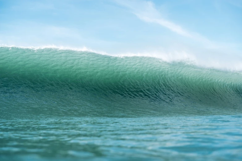 a man riding a wave in the ocean on top of his surfboard