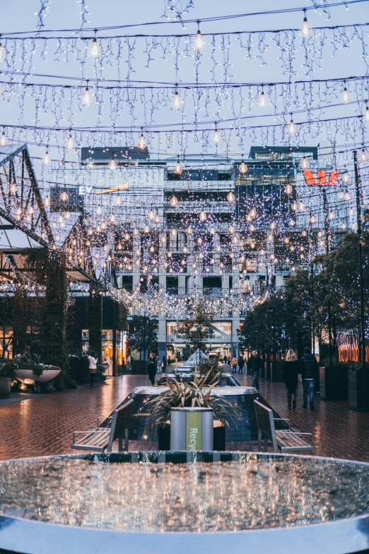 a boat is sitting in the water with christmas lights strung over it