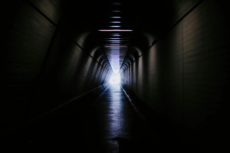 an empty dark tunnel with no people inside