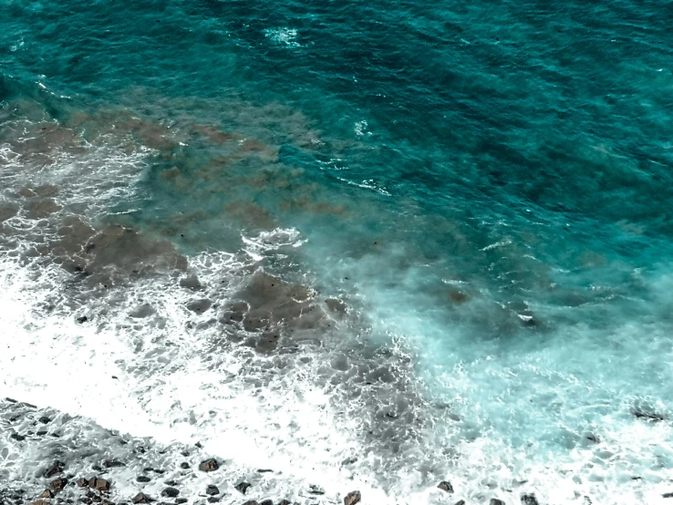 a large wave coming into shore with it's surf