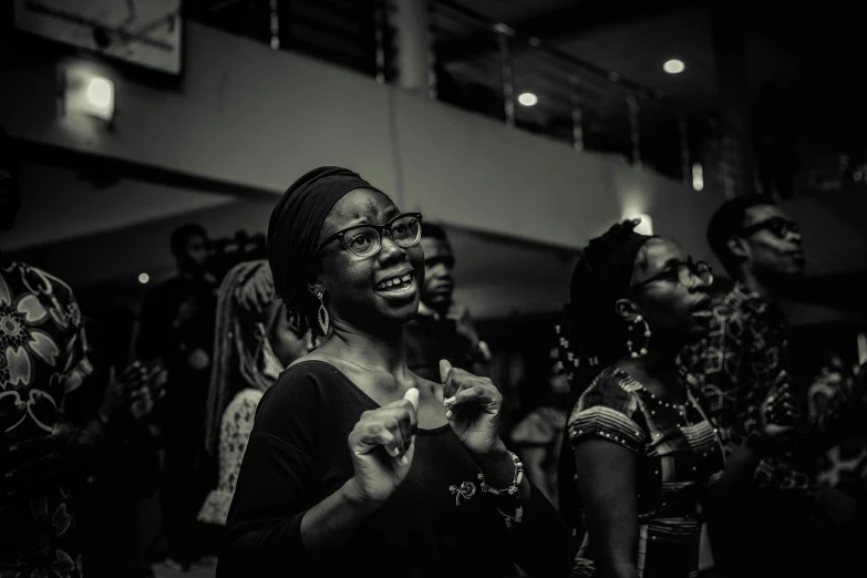 black woman in an audience with people dressed in costumes