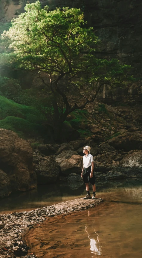 a man standing on the edge of a river