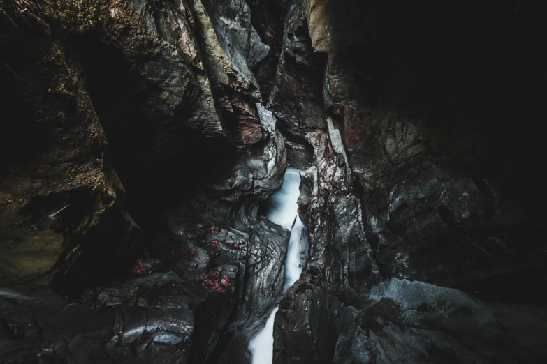 waterfall in rocks in night time with dark sky