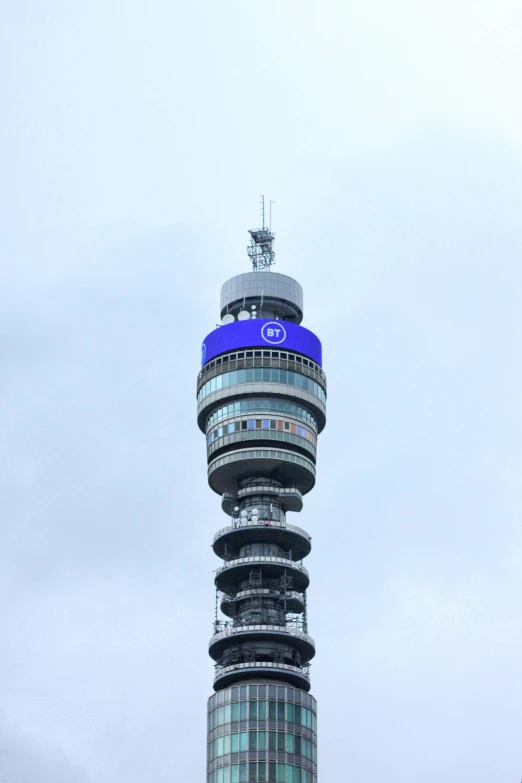 there is a large tower with a blue sign on top of it