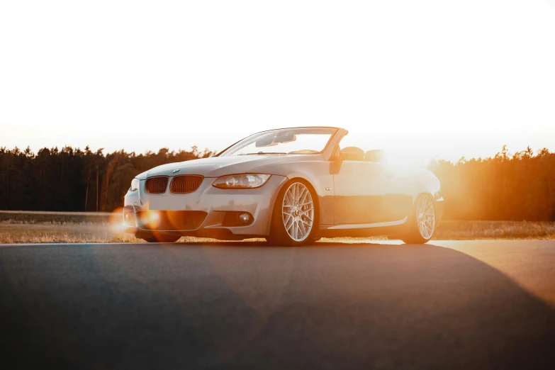 a car sits on the street with sunlight shining through it