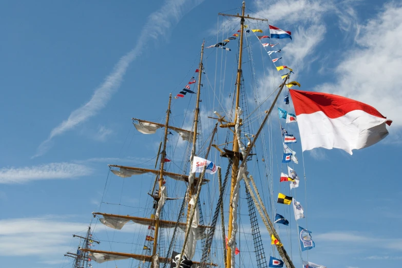 a pirate ship with flags on the mast