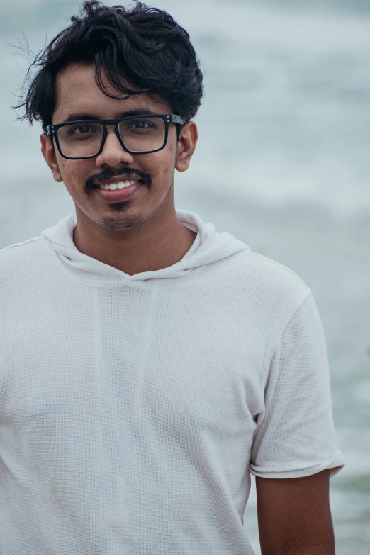 a man is standing in front of the water