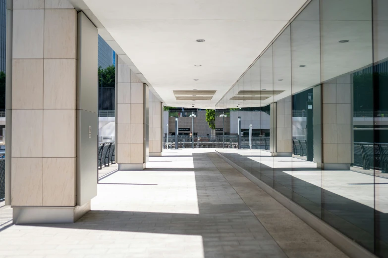 the walkway is lined with chairs and tall windows