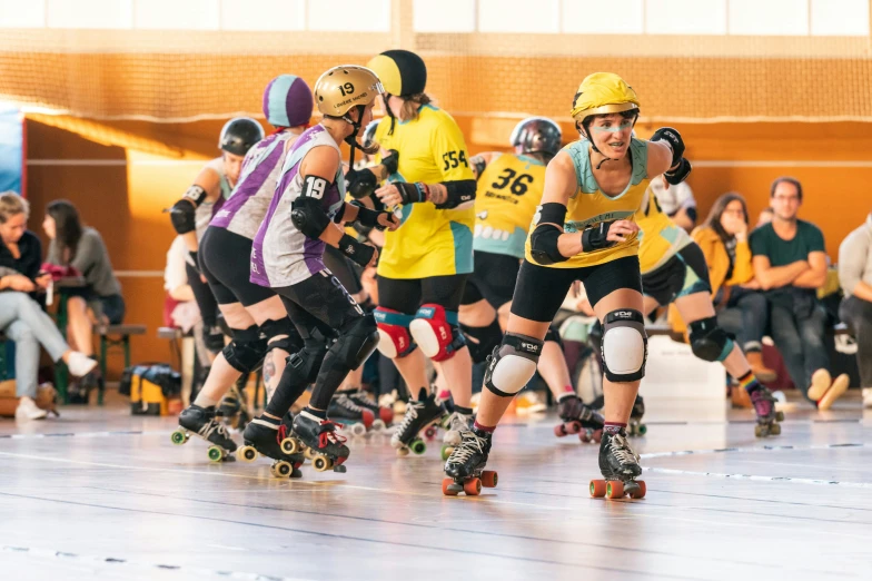 several roller derby skaters are racing along a track