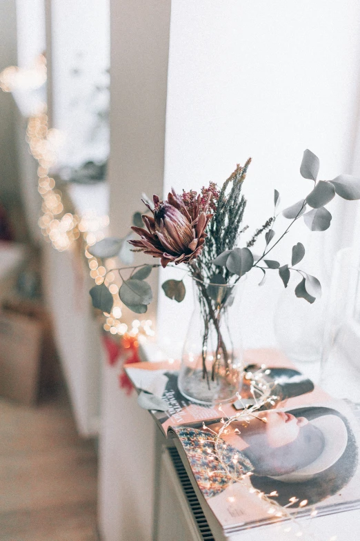 the vase is filled with pink flowers on a table