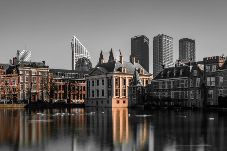 black and white pograph of city buildings and a body of water