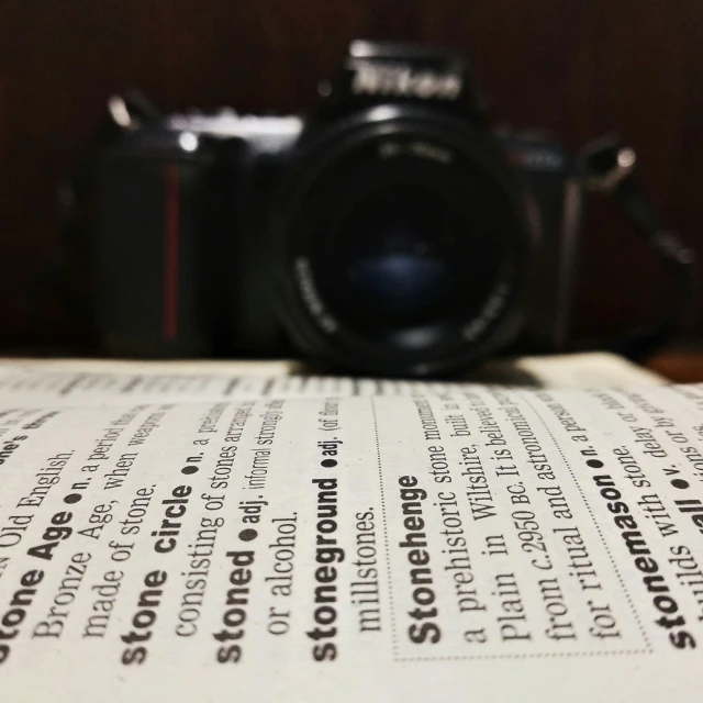 a camera on top of a paper in front of it