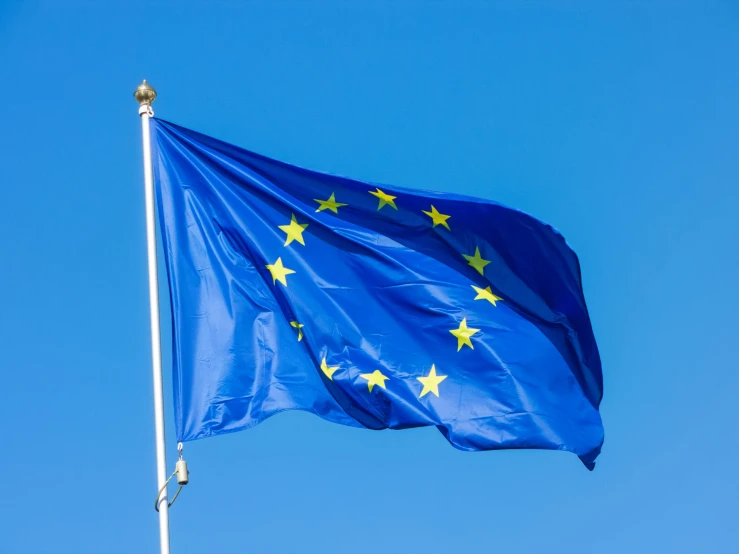a european flag is flying high in the sky