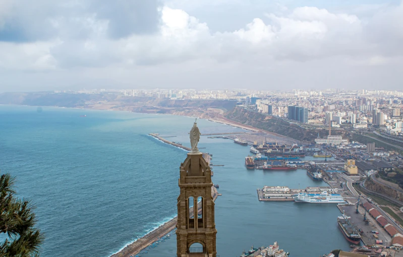 a clock tower towering over the water of a city