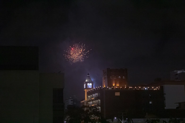 fireworks are lit up the night sky in the city